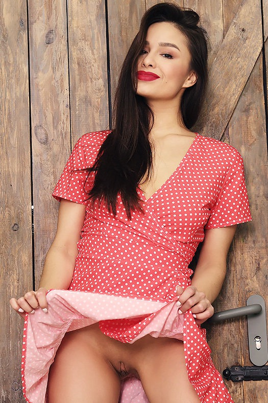 Astrid Herrara in a Red Polka-Dot Skirt by a Wooden Wall