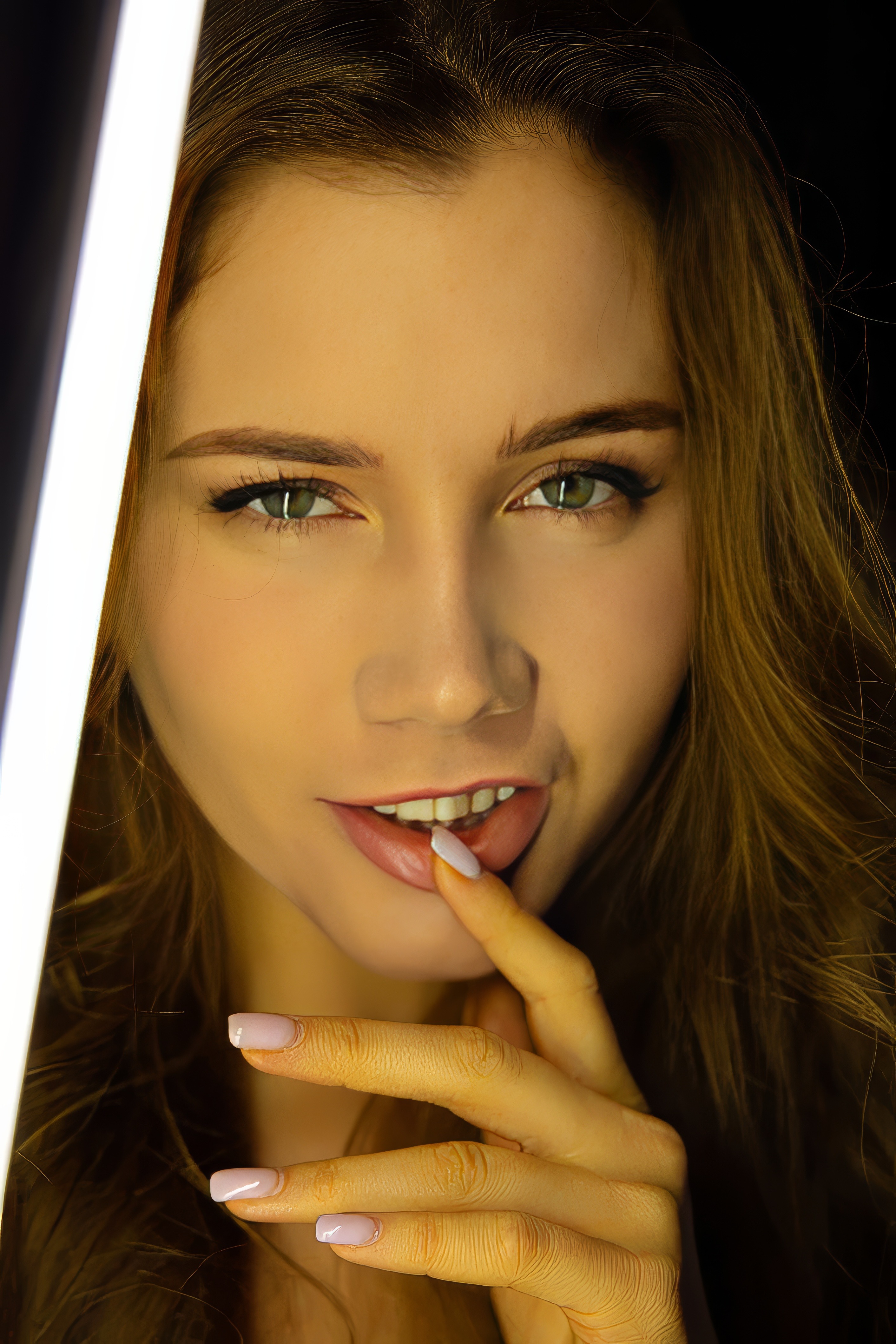 Neon-Lit Nude Posing in a Dark Studio